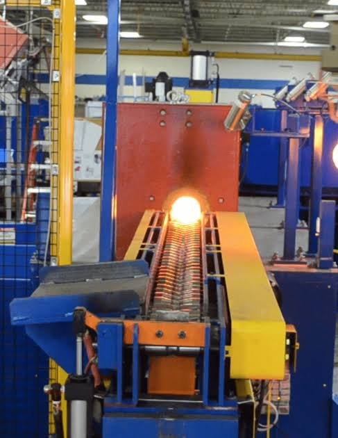 Heated billet pressed into forging dies